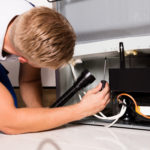 Male Technician Checking Refrigerator