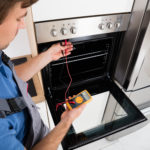 Male Technician Checking Oven