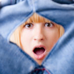 Shocked Woman with Torn Jeans