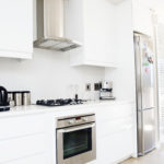 Modern, upmarket, white and stainless steel domestic kitchen