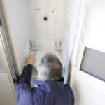 Man repairing refrigerator