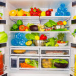 Full open fridge with lots of vegetables