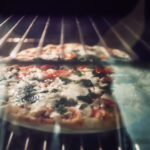 Homemade pizza is baked in a modern electric oven