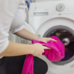 Young woman doing laundry