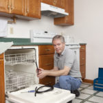 Plumber Working in Kitchen